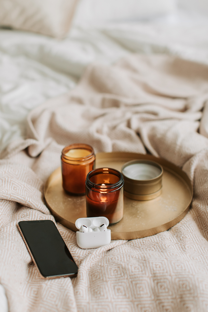 Gadgets and Scented Candles on Bronze Tray